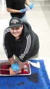 Stop the Bleed Training - Students using gauze with fake blood being pushed through to simulate the process.